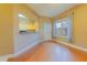 Cozy room featuring hardwood flooring, a window, and access to the kitchen at 2418 Formosa Ave, Orlando, FL 32804