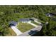 Aerial view displaying three houses with ample yard space, complemented by verdant surroundings at 248 S Virginia Ave, Deland, FL 32724