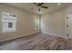 Bright bedroom featuring wood floors, two windows, and a ceiling fan at 248 S Virginia Ave, Deland, FL 32724