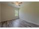 Bedroom with hardwood flooring, ceiling fan, neutral paint and a window for natural light at 248 S Virginia Ave, Deland, FL 32724
