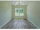 Bright dining room featuring wood floors, a window, and a modern light fixture at 248 S Virginia Ave, Deland, FL 32724