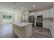 Modern kitchen featuring stainless steel appliances, stylish pendant lighting, and island at 248 S Virginia Ave, Deland, FL 32724