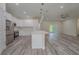 Open-concept kitchen with white cabinets, stainless steel appliances, and a spacious island at 248 S Virginia Ave, Deland, FL 32724