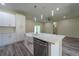 Bright, modern kitchen with an island, white cabinetry, stainless appliances, and an open floor plan at 248 S Virginia Ave, Deland, FL 32724