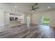 Bright living space with modern flooring and view of kitchen and backyard at 248 S Virginia Ave, Deland, FL 32724