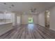 Open living room with modern flooring flowing to kitchen and a sliding glass door at 248 S Virginia Ave, Deland, FL 32724