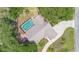 Aerial view of a home with a screened-in pool and spacious backyard surrounded by mature trees at 25 Pine Glen Dr, Debary, FL 32713