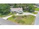 Beautiful aerial view of a well-maintained house with a long driveway, lush lawn and mature landscaping at 25 Pine Glen Dr, Debary, FL 32713