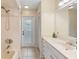 Bright bathroom featuring a shower-tub combo and neutral tile at 25 Pine Glen Dr, Debary, FL 32713