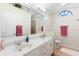 Bright bathroom with a double vanity, a large mirror, and natural light from a window at 25 Pine Glen Dr, Debary, FL 32713