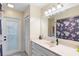 Neat bathroom featuring a single sink vanity, floral shower curtain, and ample lighting at 25 Pine Glen Dr, Debary, FL 32713