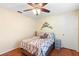 Cozy bedroom with a ceiling fan, and a comfortable bed with stylish linens at 25 Pine Glen Dr, Debary, FL 32713