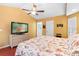 Cozy bedroom with warm colors, TV, and ensuite bathroom at 25 Pine Glen Dr, Debary, FL 32713