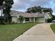 Charming, one-story home with a well-maintained lawn, mature trees, and a long driveway at 25 Pine Glen Dr, Debary, FL 32713
