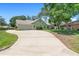 Charming single-story home with a long driveway, mature trees, and a well-maintained lawn at 25 Pine Glen Dr, Debary, FL 32713