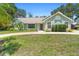 Charming single-story home with a well-maintained lawn, mature trees, and a welcoming entrance at 25 Pine Glen Dr, Debary, FL 32713