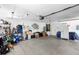 Spacious garage with ample storage, shelving, tools, and a refrigerator at 25 Pine Glen Dr, Debary, FL 32713
