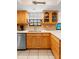 Bright kitchen with wood cabinets, quartz countertops, and stainless steel dishwasher at 25 Pine Glen Dr, Debary, FL 32713