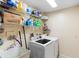 Functional laundry room with shelving and a modern washer and dryer at 25 Pine Glen Dr, Debary, FL 32713