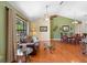 Cozy living room with hardwood floors, a ceiling fan, and a dining area bathed in natural light at 25 Pine Glen Dr, Debary, FL 32713