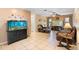 Relaxing living room with tile floors, an aquarium, and comfortable leather seating at 25 Pine Glen Dr, Debary, FL 32713