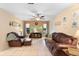 Spacious living room with tile floors, ceiling fan, and comfortable leather seating arrangement at 25 Pine Glen Dr, Debary, FL 32713