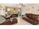 Relaxing living room with leather furniture, a large TV, and neutral wall colors at 25 Pine Glen Dr, Debary, FL 32713