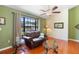 Cozy living room area with hardwood floors and a beautiful natural-light-filled window at 25 Pine Glen Dr, Debary, FL 32713