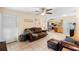 Cozy living room with leather furniture, tile floors, and a view into the kitchen at 25 Pine Glen Dr, Debary, FL 32713