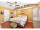 Comfortable main bedroom with wooden floors, a cozy bed, and charming decor at 25 Pine Glen Dr, Debary, FL 32713