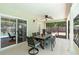 Inviting covered patio with ceiling fan, dining table, and screened-in view of pool at 25 Pine Glen Dr, Debary, FL 32713