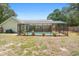 Backyard showing the screened-in pool and patio area, bordered by the lawn at 25 Pine Glen Dr, Debary, FL 32713