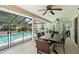 Covered patio with a view of the screened-in pool and lush backyard with ample seating at 25 Pine Glen Dr, Debary, FL 32713
