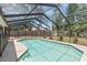 The sparkling screened-in pool provides a refreshing backyard oasis at 25 Pine Glen Dr, Debary, FL 32713