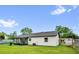 A well-maintained backyard with lush green grass and a screened in lanai, perfect for outdoor activities at 2517 Oak Hollow Dr, Kissimmee, FL 34744