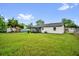 The home features a spacious backyard, a screen patio and white siding at 2517 Oak Hollow Dr, Kissimmee, FL 34744