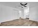 This bedroom features a ceiling fan, closet, ensuite bathroom, and light wood floors at 2517 Oak Hollow Dr, Kissimmee, FL 34744
