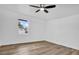 This bedroom features a ceiling fan, wood flooring, and a window at 2517 Oak Hollow Dr, Kissimmee, FL 34744