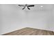 A clean, minimalist bedroom with modern flooring, ceiling fan, and freshly painted walls at 2517 Oak Hollow Dr, Kissimmee, FL 34744