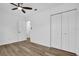 This bedroom features a ceiling fan, wood flooring and a closet at 2517 Oak Hollow Dr, Kissimmee, FL 34744