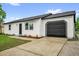 A well-maintained single-Gathering home featuring a paved driveway, attached garage, and freshly landscaped front yard at 2517 Oak Hollow Dr, Kissimmee, FL 34744