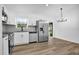Modern kitchen featuring stainless steel appliances, ample counter space, and natural light from a sliding glass door at 2517 Oak Hollow Dr, Kissimmee, FL 34744
