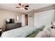 Comfortable bedroom featuring a ceiling fan and a dresser with a mirror for added style and convenience at 26 Ocean Shore Dr, Ormond Beach, FL 32176