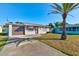 Charming one-story home with a well-maintained front yard and a driveway leading to a garage at 26 Ocean Shore Dr, Ormond Beach, FL 32176