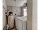 Functional laundry room with modern washer and dryer units and storage options at 26 Ocean Shore Dr, Ormond Beach, FL 32176