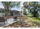 Expansive backyard featuring mature trees, a screened-in porch, and a comfortable patio area at 2842 English Dr, Deltona, FL 32738