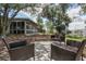 Spacious backyard with a patio seating area and mature trees provides a serene outdoor retreat at 2842 English Dr, Deltona, FL 32738