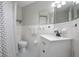 Cozy bathroom with patterned tile flooring, a white vanity, and a shower featuring a stylish curtain at 2842 English Dr, Deltona, FL 32738