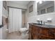 Bathroom featuring a carved wood vanity and a shower/tub combination with white patterned tile at 2842 English Dr, Deltona, FL 32738