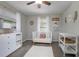 Charming Bedroom with ample natural light, a white crib, dresser, and changing table set on soft carpeting at 2842 English Dr, Deltona, FL 32738